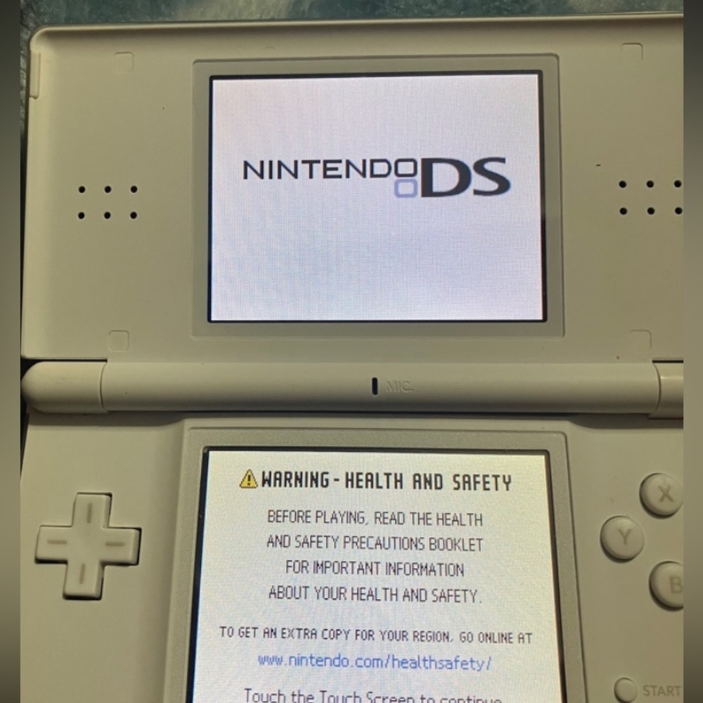 Nintendo DS Lite in white. With charging cord.